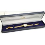 AVIA: ladies gold plated quartz wristwatch, with lozenge shaped champagne dial and on a gold