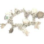 Hallmarked silver charm bracelet with ten charms and hallmarked silver padlock clasp, 30g, L: 20 cm.