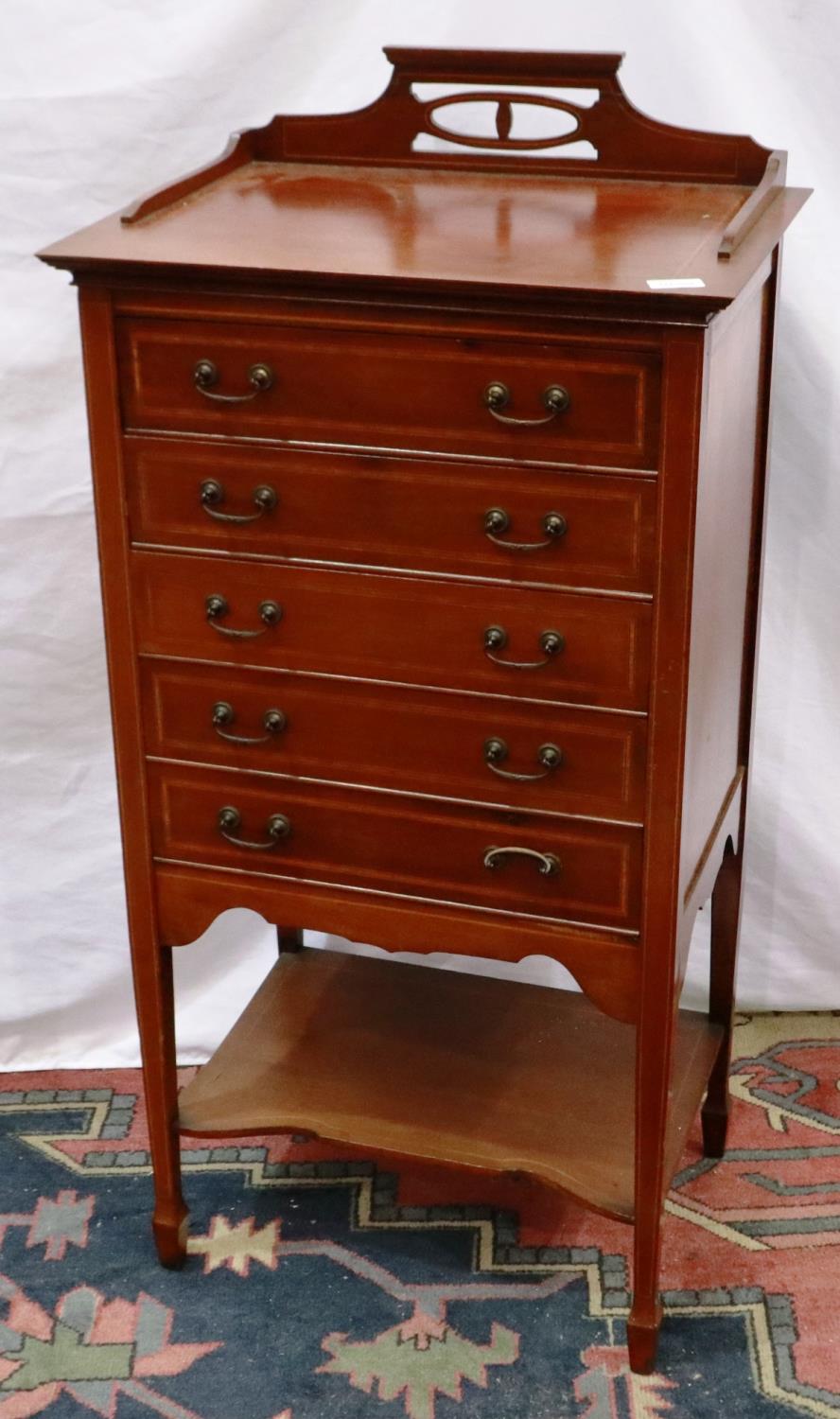 An Edwardian inlaid walnut music chest comprising flight of five drawers with hinged fascias, 53 x