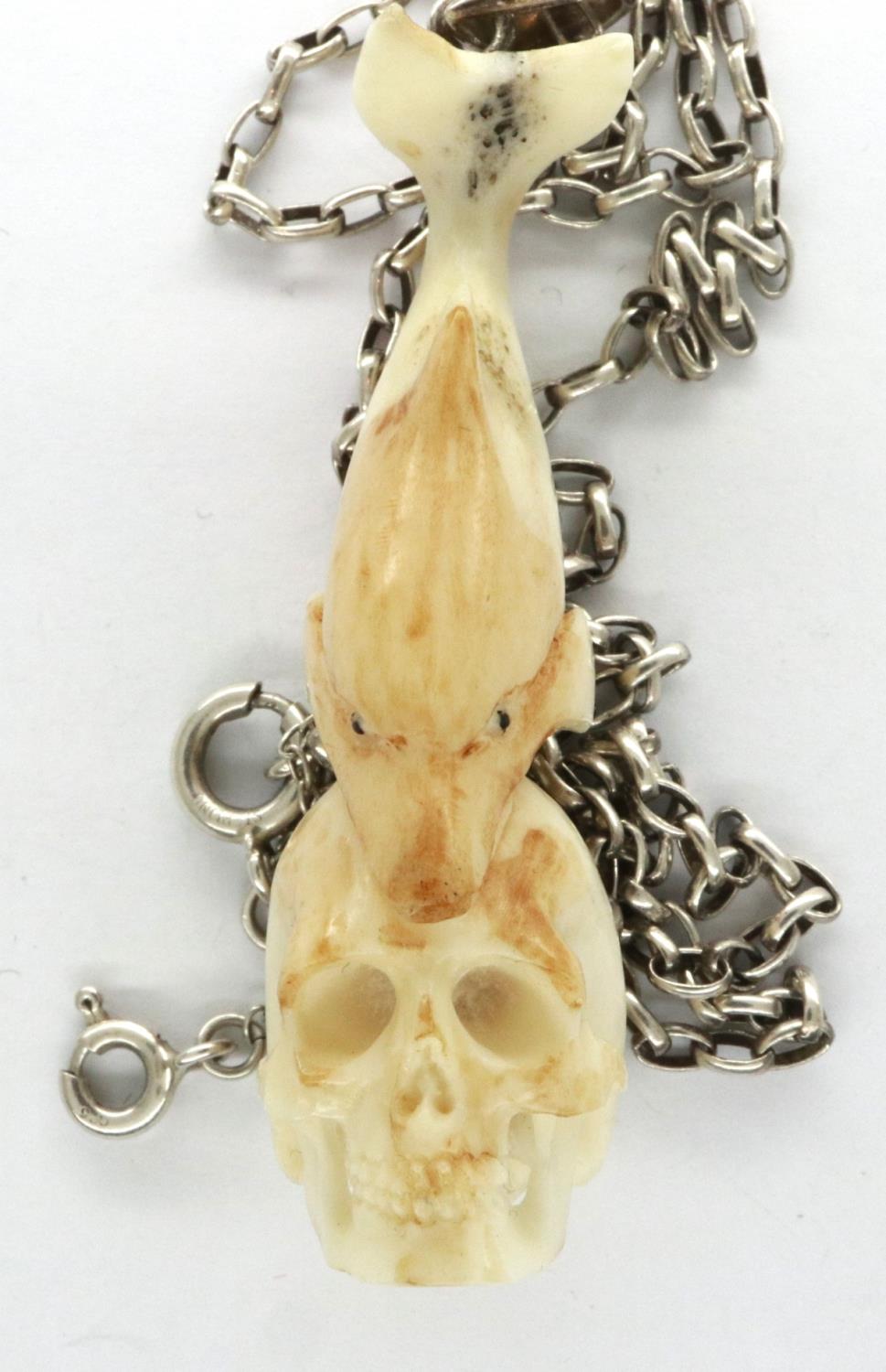 Meerschaum skull and dolphin form pendant, on a 925 silver neck chain, L: 50 cm. P&P Group 1 (£14+