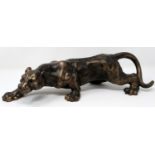 Bronzed cast iron stalking male panther, L: 30 cm. P&P Group 3 (£25+VAT for the first lot and £5+VAT