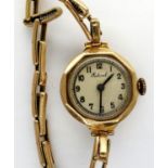 9ct gold cased wristwatch on a 9ct gold bracelet, working at lotting. P&P Group 1 (£14+VAT for the
