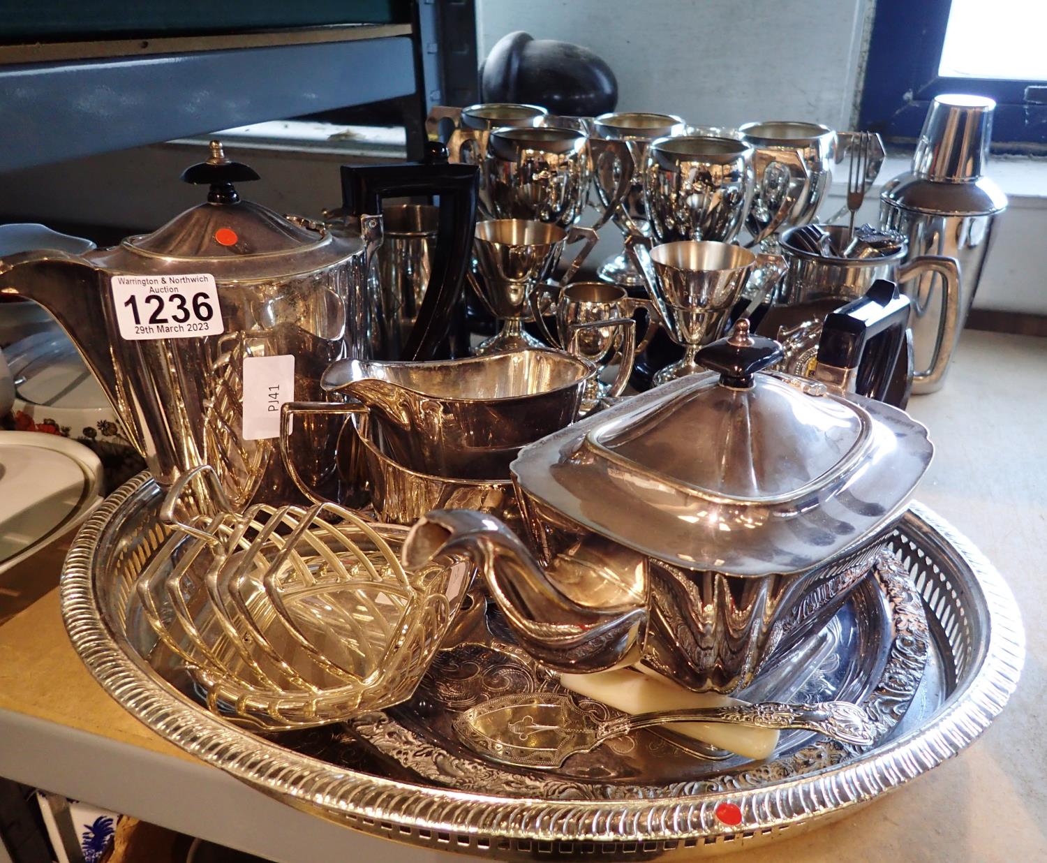 Large quantity of silver plate, including a four piece tea service, trays, trophies etc, largest