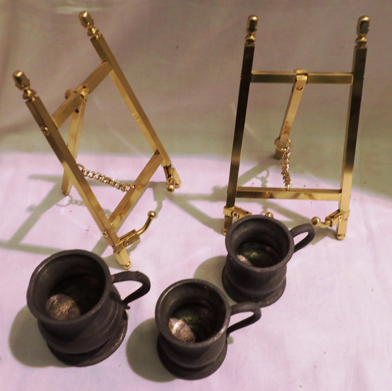 Pair of small brass A frames, each H: 16 cm, and three miniature pewter measures. P&P Group 2 (£18+