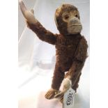 Monkey doll figure with moving arms in good condition. P&P Group 1 (£14+VAT for the first lot and £