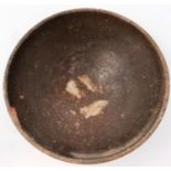 A large Song Dynasty bowl, tapered and footed, glazed in brown, D: 16 cm, H: 7 cm. Loss to rim and a