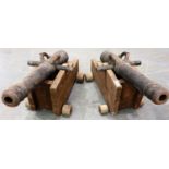 Pair of reproduction French saluting cannons, with cast iron barrels raised on wooden carriages,