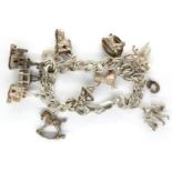 925 silver charm bracelet with thirteen charms, L: 18 cm. P&P Group 1 (£14+VAT for the first lot and