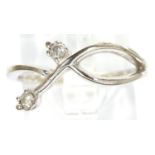 9ct white gold and diamond crossover ring, size L/M, 1.5g. P&P Group 1 (£14+VAT for the first lot