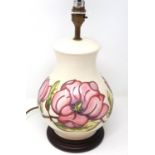 Moorcroft table lamp in the Magnolia pattern, with shade, overall H: 57 cm, crazing throughout. P&