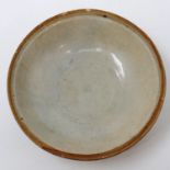 A celadon glazed Ming Dynasty shallow bowl, footed, D: 15 cm, H: 4 cm. Small chips to rim. P&P Group