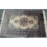 A 20th century Middle Eastern hand knotted floor rug, fringed, 180 x 120 cm. Not available for in-