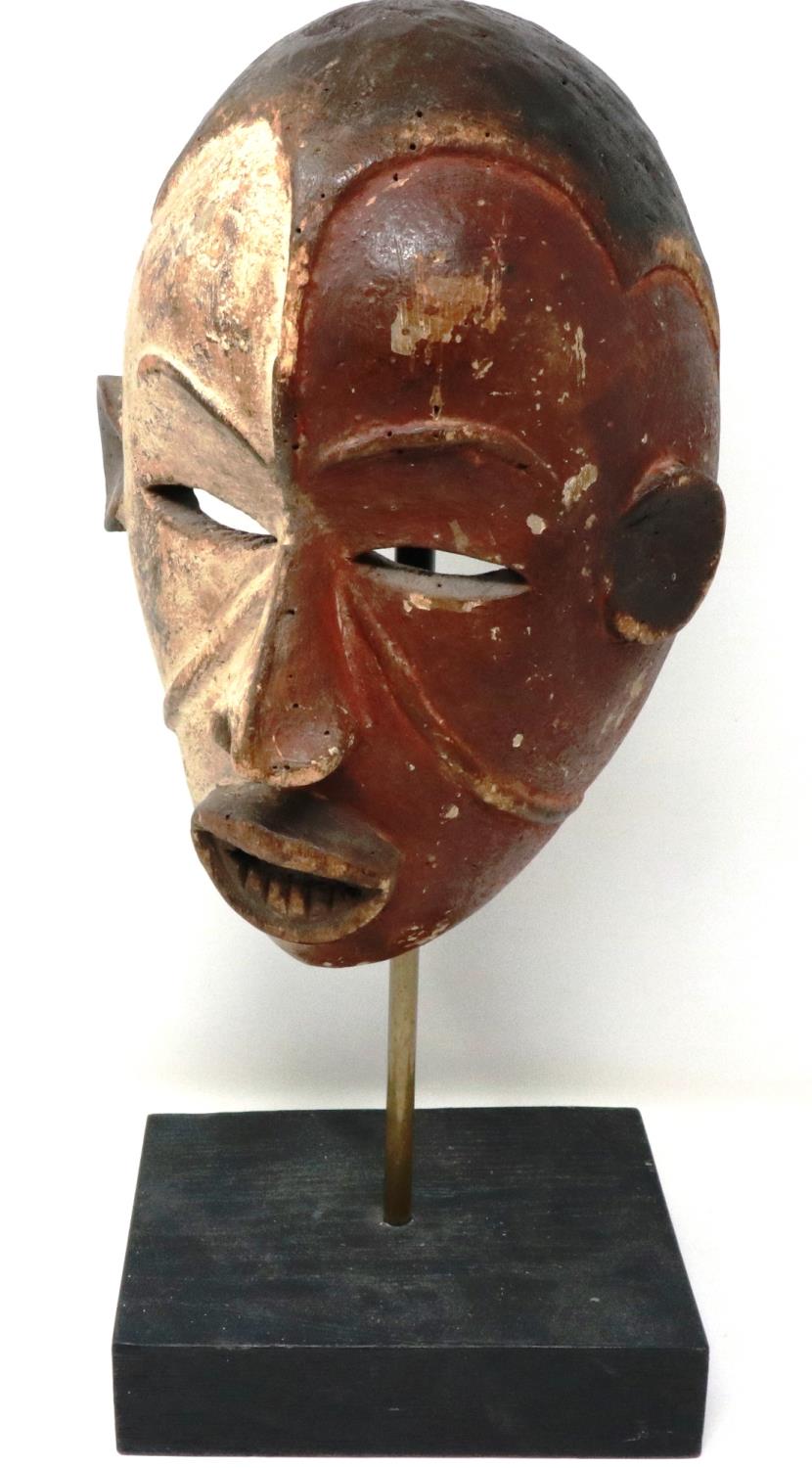 Carved wooden Tribal mask on a wooden stand, overall H: 47 cm. P&P Group 3 (£25+VAT for the first