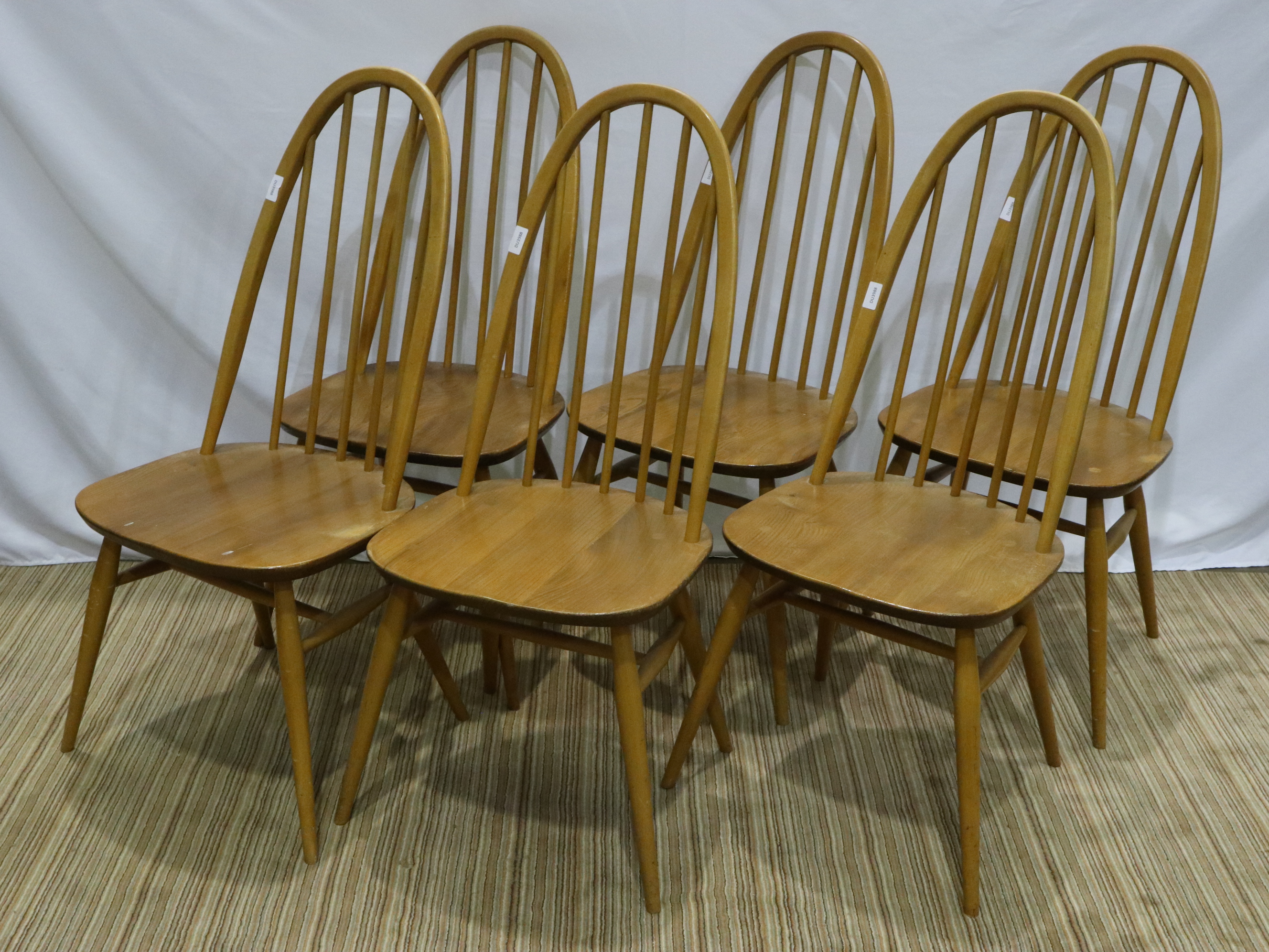 Set of six Ercol stickback dining chairs, seats of the chairs are not split, the back of one has a