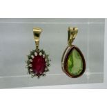 Two yellow metal pendants, one marked 9K, one set with a ruby, combined 0.9g. P&P Group 1 (£14+VAT