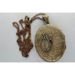 Large yellow metal locket on yellow metal chain, chain L: 60 cm, 18.5g. P&P Group 1 (£14+VAT for the