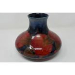 A Moorcroft squat baluster vase in the pomegranate pattern against a blue ground, H: 15 cm,