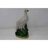 Staffordshire bird figurine, heavy crazing throughout and small loss to beak, H: 26 cm. P&P Group