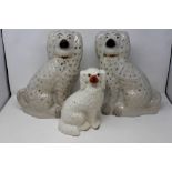 Two large Victorian Staffordshire fireside dogs and a smaller example (3), largest H: 37 cm, wear to