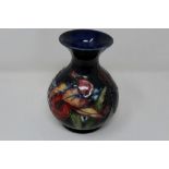 Moorcroft bulbous vase in the Orchid pattern. H: 14 cm, restoration to rim. P&P Group 1 (£14+VAT for