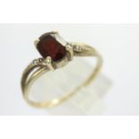9ct gold ring set with garnet and diamond shoulders, size T, 1.9g. P&P Group 1 (£14+VAT for the