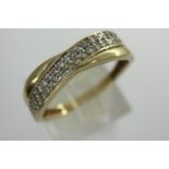9ct gold crossover ring set with cubic zirconia, size O, 1.6g. P&P Group 1 (£14+VAT for the first