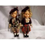 Two Rogark Scottish dolls, celluloid with sleep eyes, arm jointed arms, piper and dancer, in very
