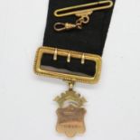 9ct gold Parish of Inverkip war medal, 6.5g, on a war ribbon with yellow metal mount and suspension.