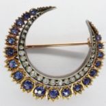 Unmarked rose gold crescent moon brooch set with graduating diamonds and sapphires, D: 30 mm, 6.