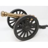 Napoleonic Wars: a substantial bronze table cannon raised on a cast iron carriage, overall L: 40 cm.