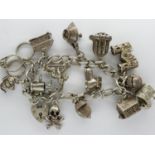 Hallmarked silver charm bracelet with hallmarked silver padlock clasp and fourteen charms, L: 16 cm,