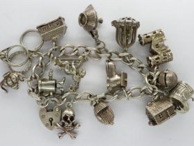 Hallmarked silver charm bracelet with hallmarked silver padlock clasp and fourteen charms, L: 16 cm,