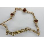 9ct gold gate bracelet with magnetic clasp set with three cherry amber cabochons, L: 20 cm, 6.1g. UK