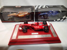 Three 1/18 scale Formula 1 cars; Minichamps McLaren MP4/12 testcar- Coulthard, Minichamps Prost team