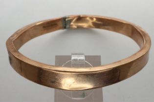 9ct rose gold bangle with metal core, D: 70 mm, 150g, slightly dented with solder repair. UK P&P