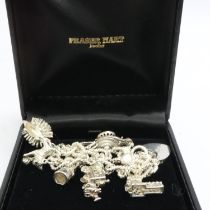 Hallmarked silver charm bracelet with seven charms, padlock clasp and safety chain, L: 18 cm, 47g.