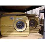 Two Bush radios, model TR82, one blue and one burgundy with cables, working at lotting. All