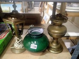 Brass oil lamp with green glass shade and an electric example. Not available for in-house P&P