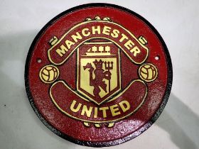 Cast iron Manchester United plaque. D: 25cm. UK P&P Group 1 (£16+VAT for the first lot and £2+VAT