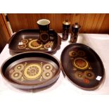Six pieces of Denby dinnerware including rectangular serving dishes a jug and salt pepper pots.