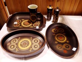 Six pieces of Denby dinnerware including rectangular serving dishes a jug and salt pepper pots.