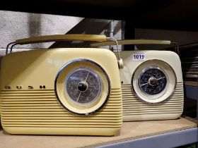 Two Bush radios, model TR82, one blue and one brown with cables, working at lotting. All