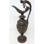 Bronze ornate Greek jug with finial in the form of a lady and cherub decoration in relief, handle