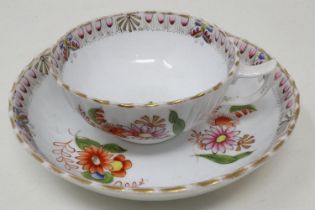 Hand painted floral teacup and bowl saucer, chip to rim of teacup and slight wear to gilt. UK P&P