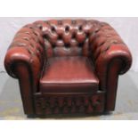 A 20th century ox blood red leather Chesterfield style armchair. Not available for in-house P&P