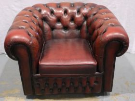 A 20th century ox blood red leather Chesterfield style armchair. Not available for in-house P&P