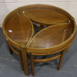Nathan: a Trinity circular teak nest of four tables, the largest with glass top D: 82 cm. Not