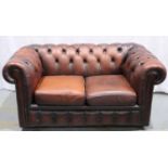 A 20th century ox blood red leather Chesterfield style two seat sofa. Not available for in-house P&P
