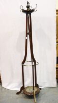 An Edwardian mahogany coat stand, tapering above a large circular base, for restoration. Not