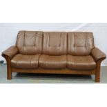Stressless: A modern brown leather three seat sofa. Not available for in-house P&P